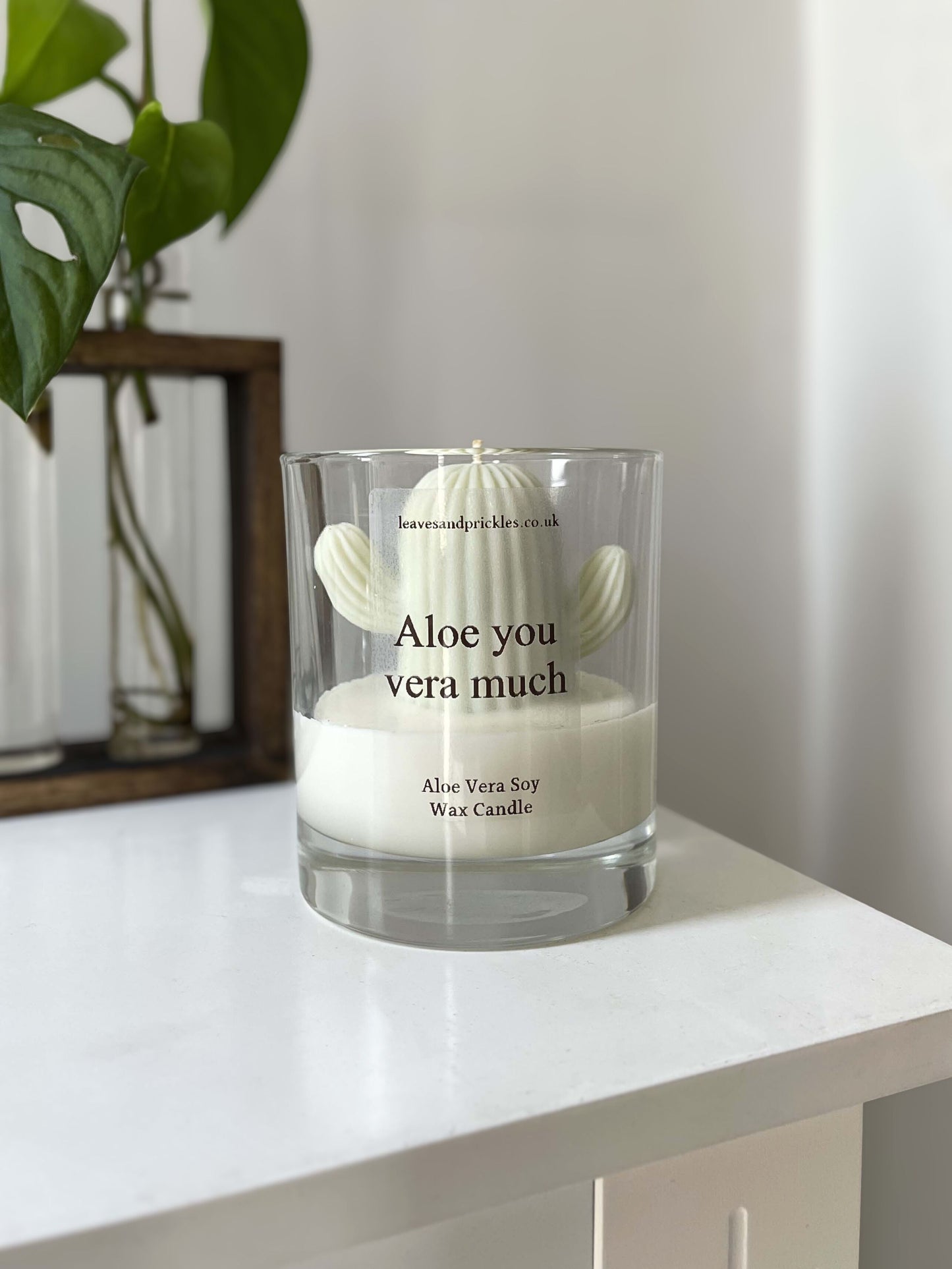 Funny green cactus candle in glass jar