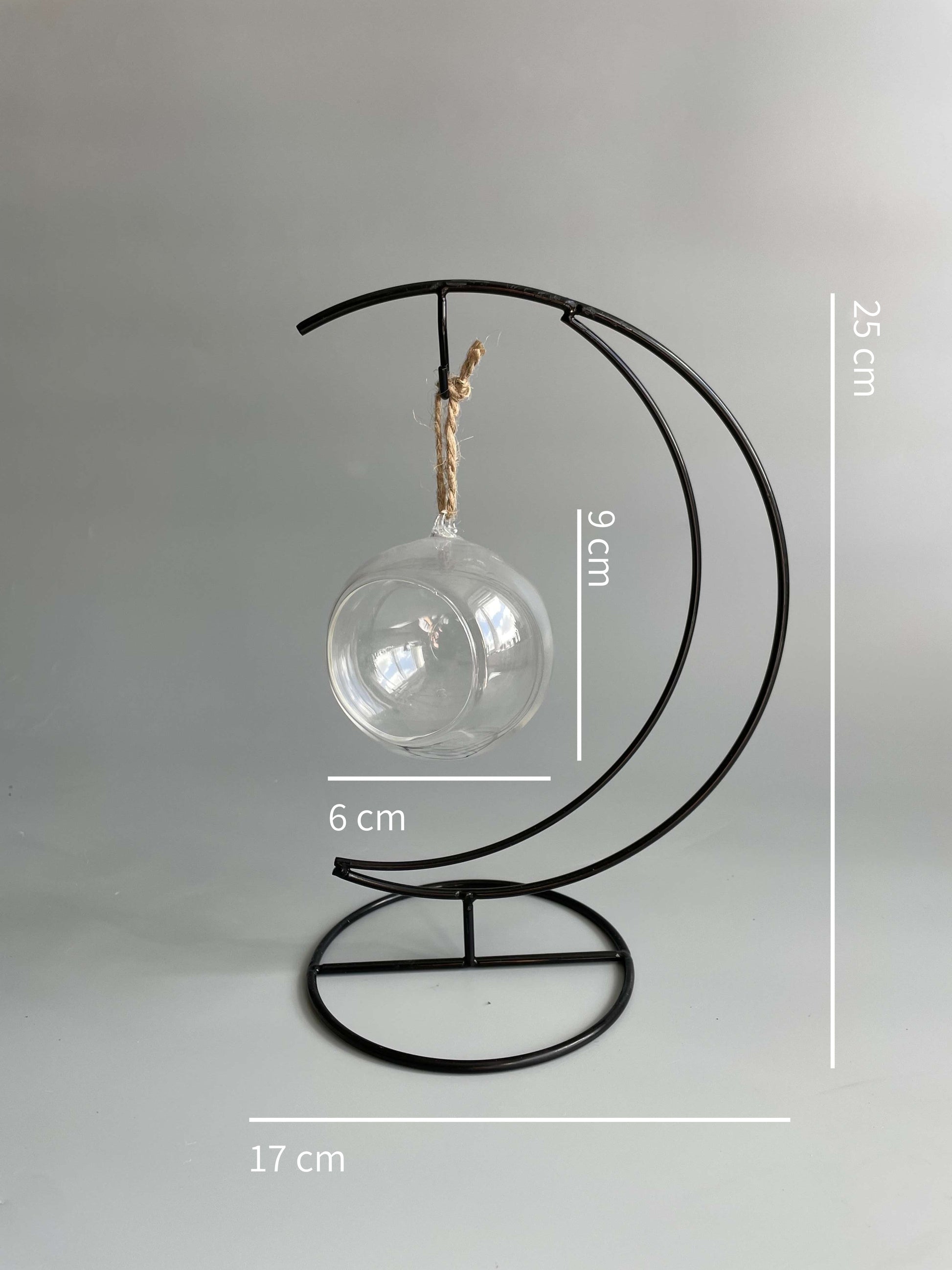 Decorative metal stand with a glass bulb on a gray background, showing measurements.