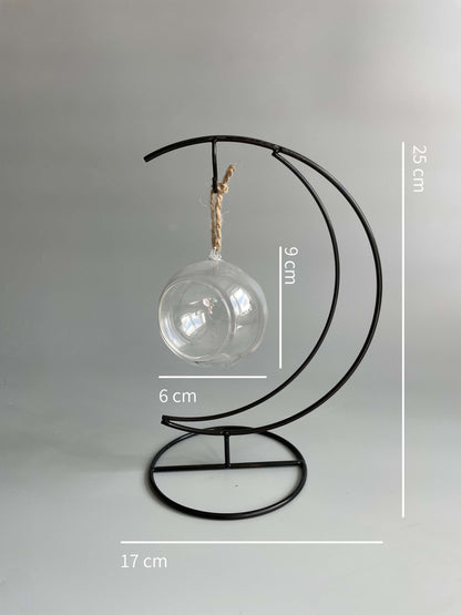 Decorative metal stand with a glass bulb on a gray background, showing measurements.
