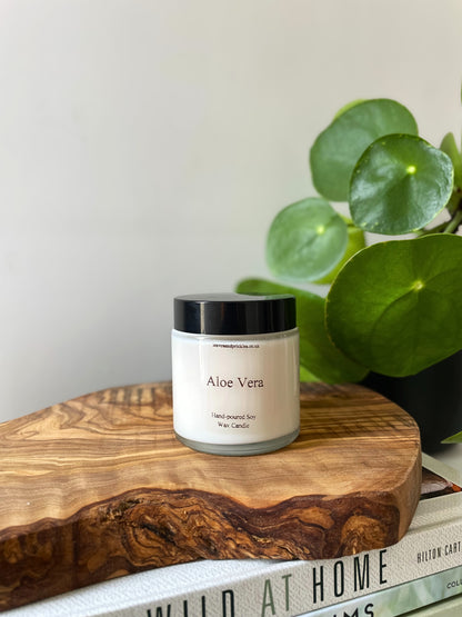 Aloe vera scented candle in a glass jar with a lid 
